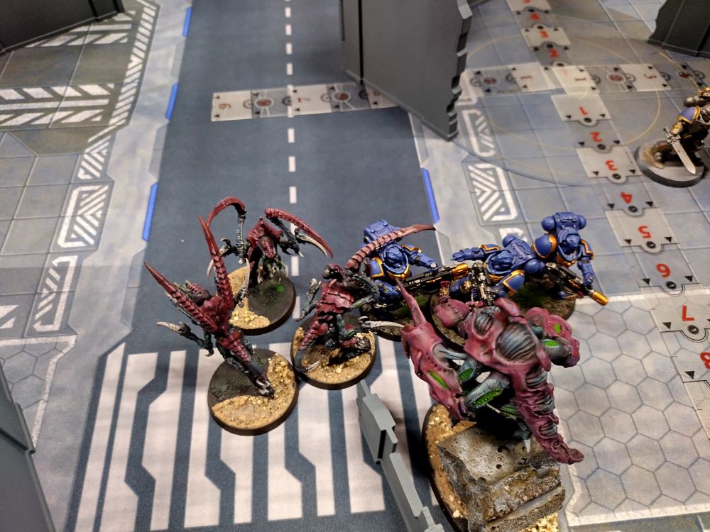 Leapers and a broodlord attempt to kill some space marines in melee