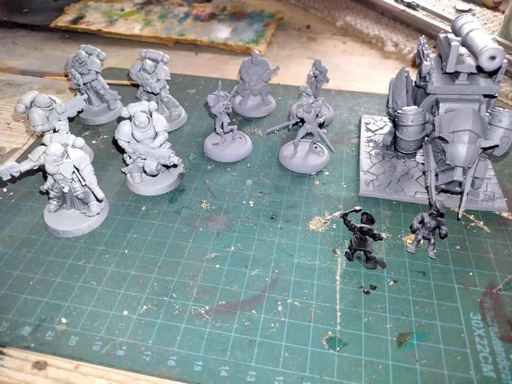 Miniatures waiting to be painted - space marine sternguard veterans, some guys from moonstone, and a halfling big-pig from kings of war