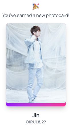 Jin, Mr Worldwide Handsome of BTS on a photocard from BCD. He's wearing all white and standing against a white background. He looks like an angel