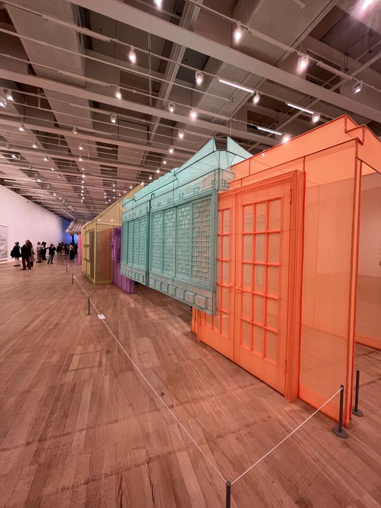 The outside of Nest/s, multicoloured home exteriors in a gallery room