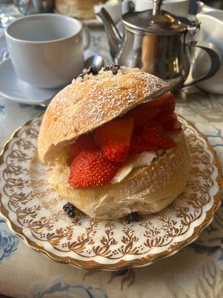 A bath bun full of strawberries and cream cheese