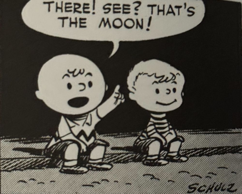 Charlie sits in the night, points at the sky, and says "There! See? That's the moon!"