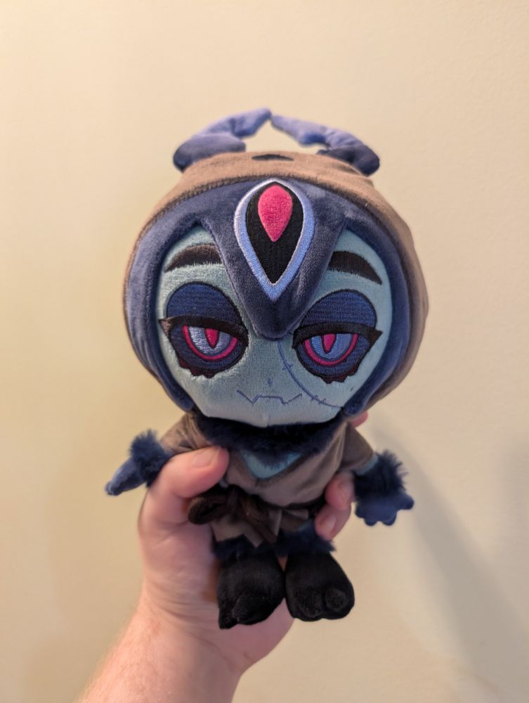 A plush zombie moth with a cloak