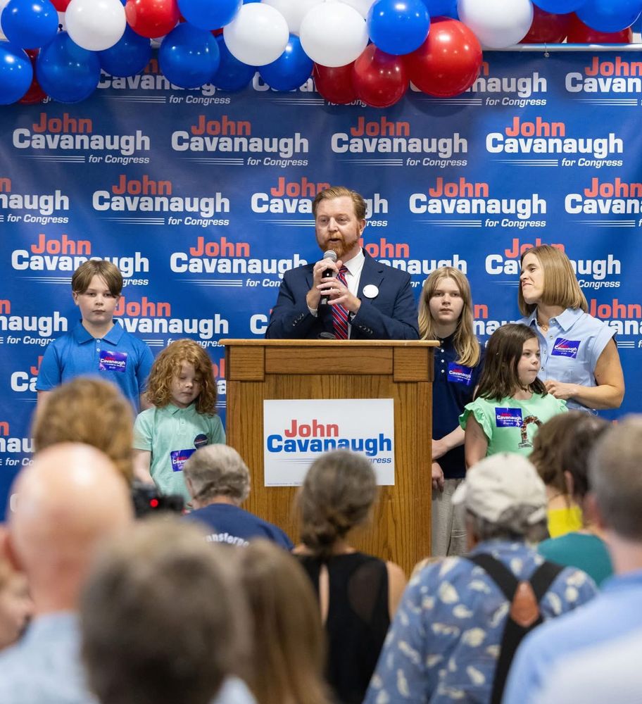 Image of Sen. John Cavanaugh and family speaking to crowd at his campaign kickoff. 
