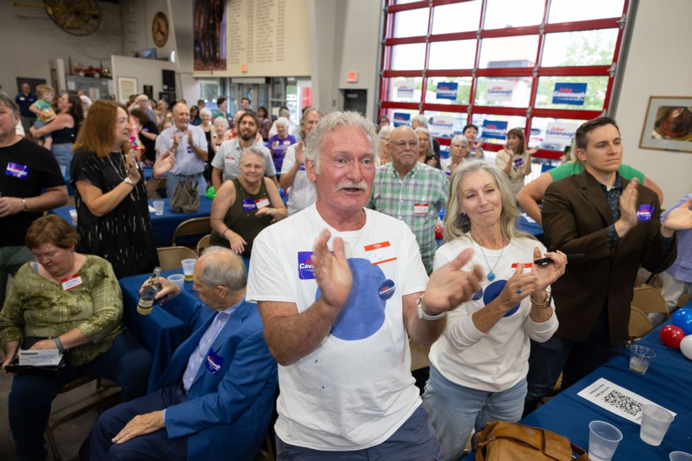 The crowd applauds during John Cavanaugh's speech.