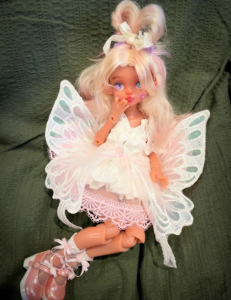 Bogun sculpt Skyland Dolls in transparent brown skin in a butterfly fairy princess type of outfit and pink fluffy hair 