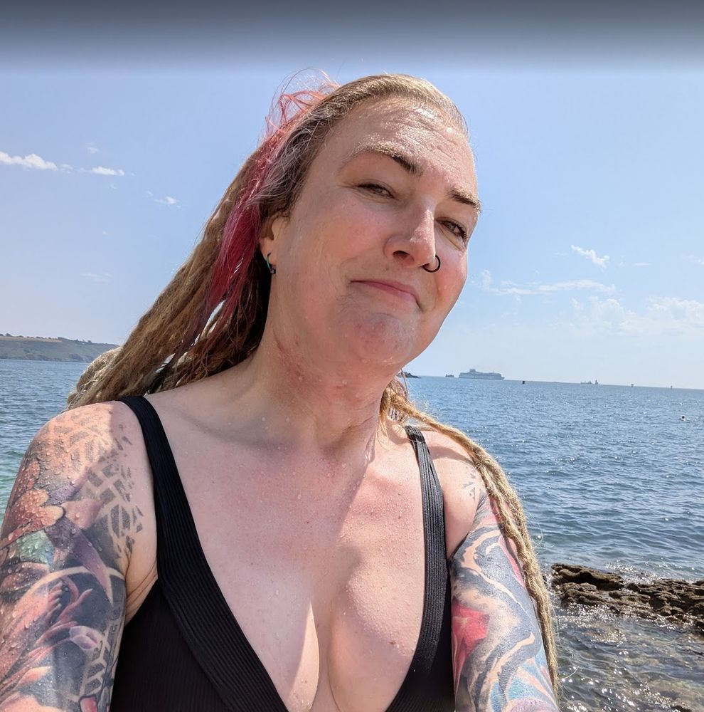 A very smug looking selfie of Lisa, in a black bikini.  She has swum in the sea and looks very pleased with herself about it 