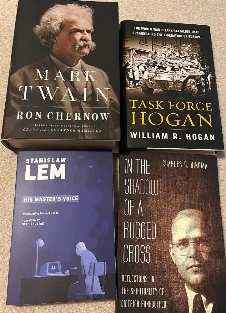 Covers of 4 books- “Mark Twain” by Chernow, “Task Force Hogan” by William Hogan, “His Master’s Voice” by Stanislaw Lem, and “In the Shadow of a Rugged Cross” by Charles Ringma. 