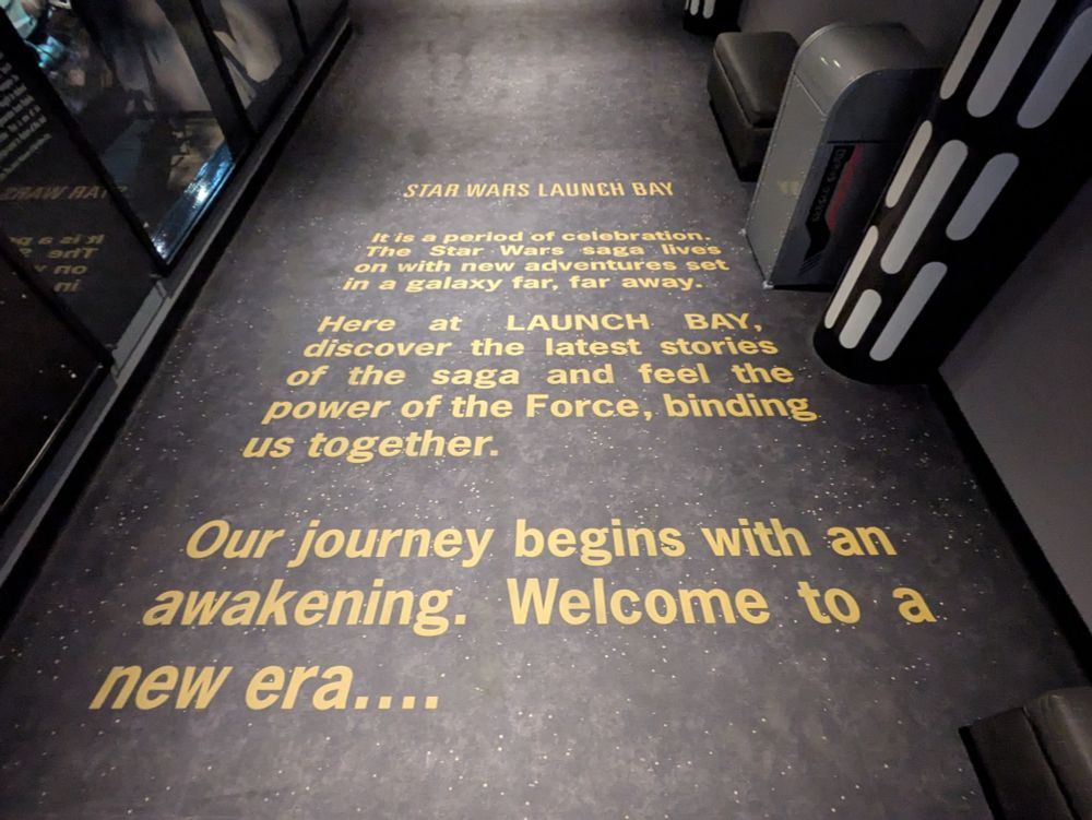 Carpet with a Star Wars crawl: STAR WARS LAUNCH BAY. It is a period of celebration. The Star Wars saga lives on with new adventures set in a galaxy, far, far away...

Here at LAUNCH BAY, discover the latest stories of the saga and feel the power of the Force, binding us together. 

Our journey begins with an awakening. Welcome to a new era...
