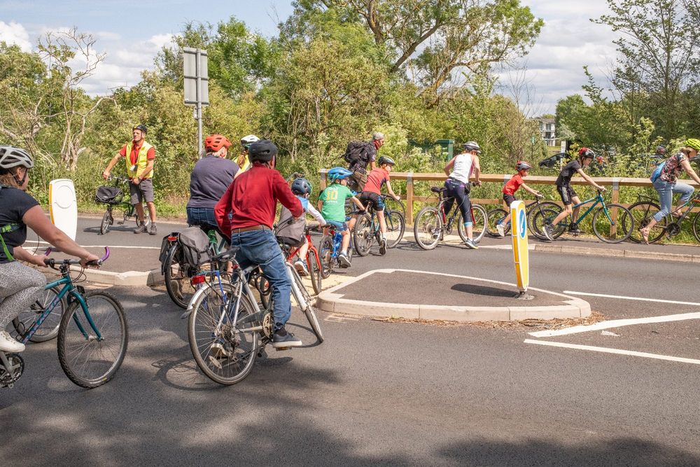 The cyclists crossing the Warwick Road in large numbers