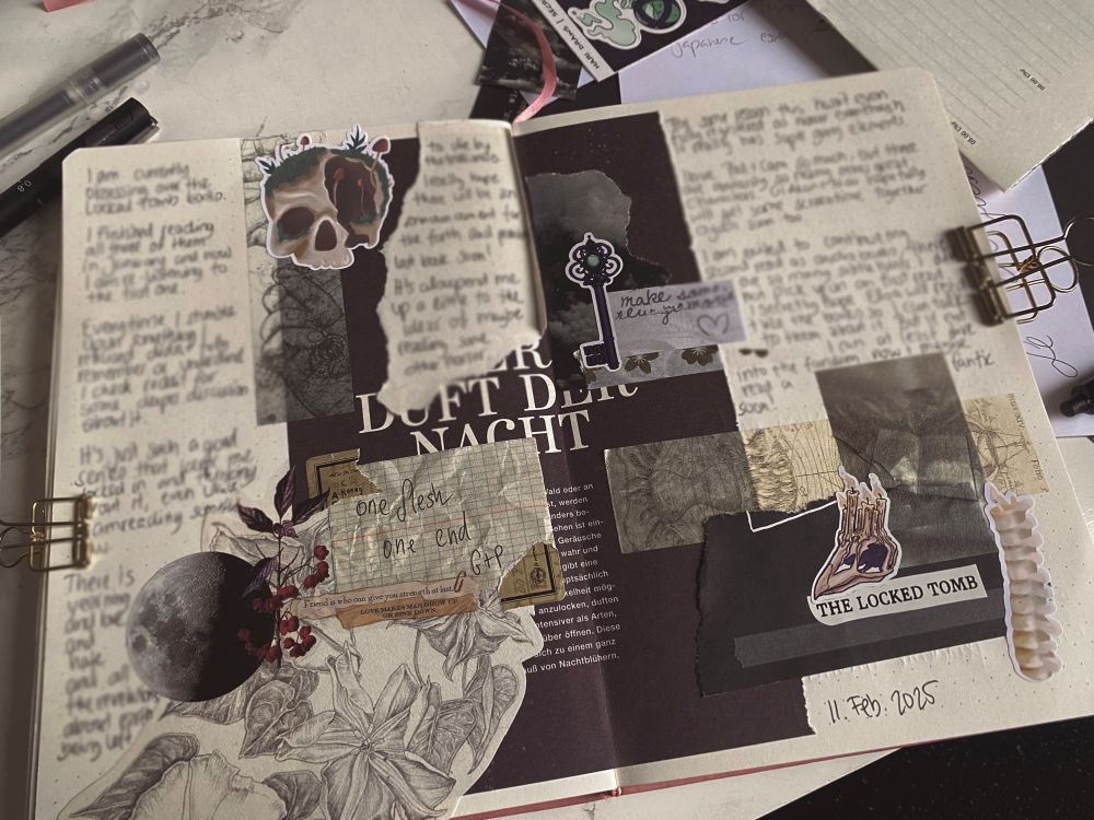 Open journal with a double page, scrap booking style design with different stickers, papers and washi tapes, all in black and gothic asthetic 