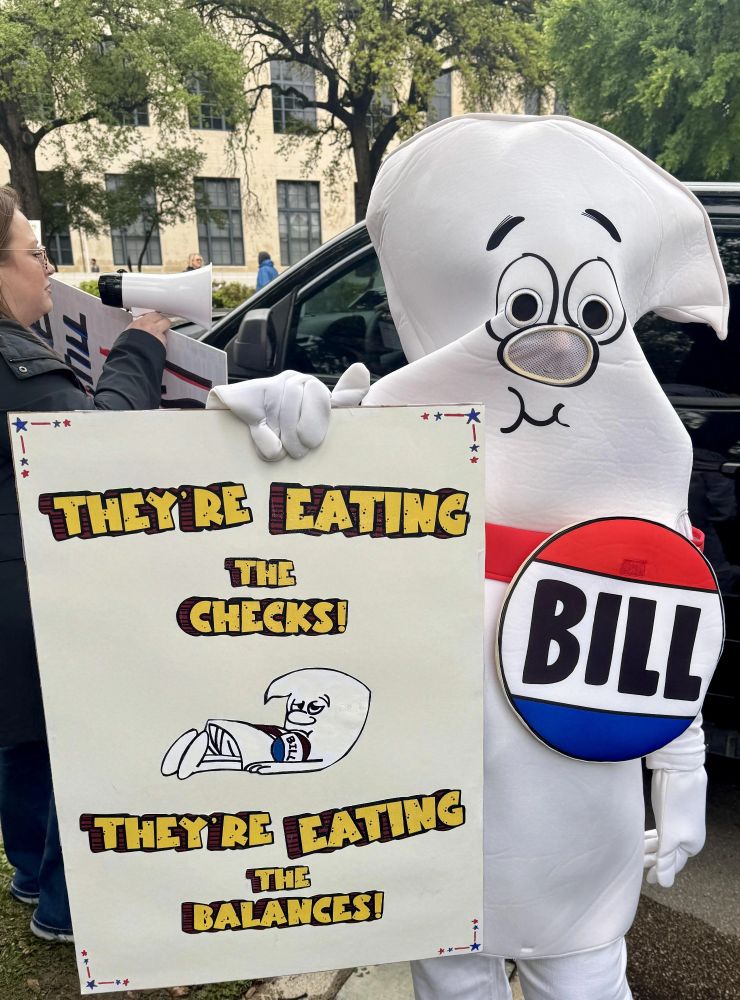They're eating the checks, they're eating the balances. Sign held by a Bill

