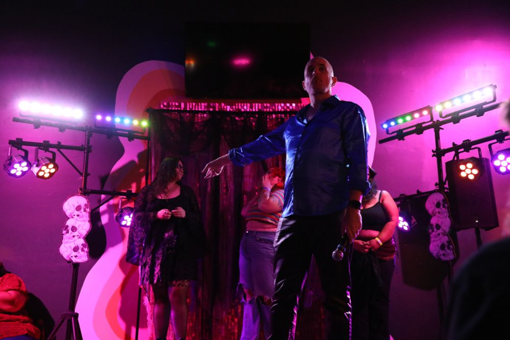 Me on stage pointing at an audience member who competed in an on stage competition