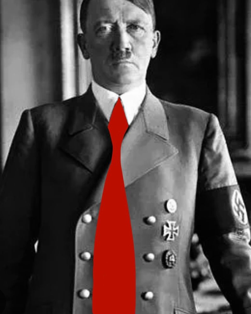 Black and white photo of Hitler wearing a big red tie.