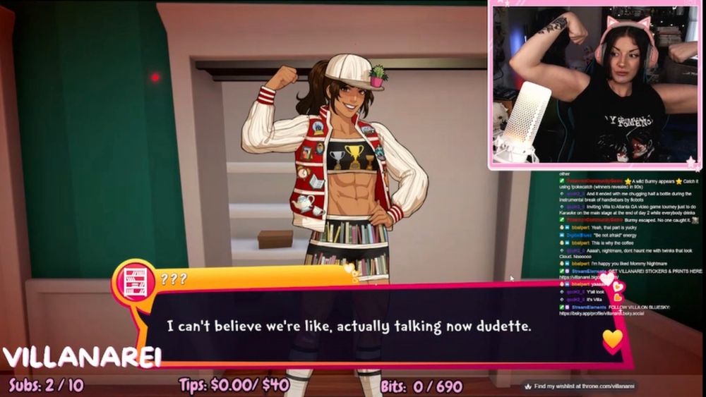 A screencap of Villanarei’s stream. She is playing Date Everything!, and the character Shelley is on the screen. Villanarei’s webcam is in the corner, and she is flexing her biceps.
