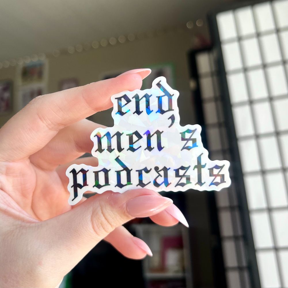 Holographic sticker that says "end men's podcasts" in Old English font