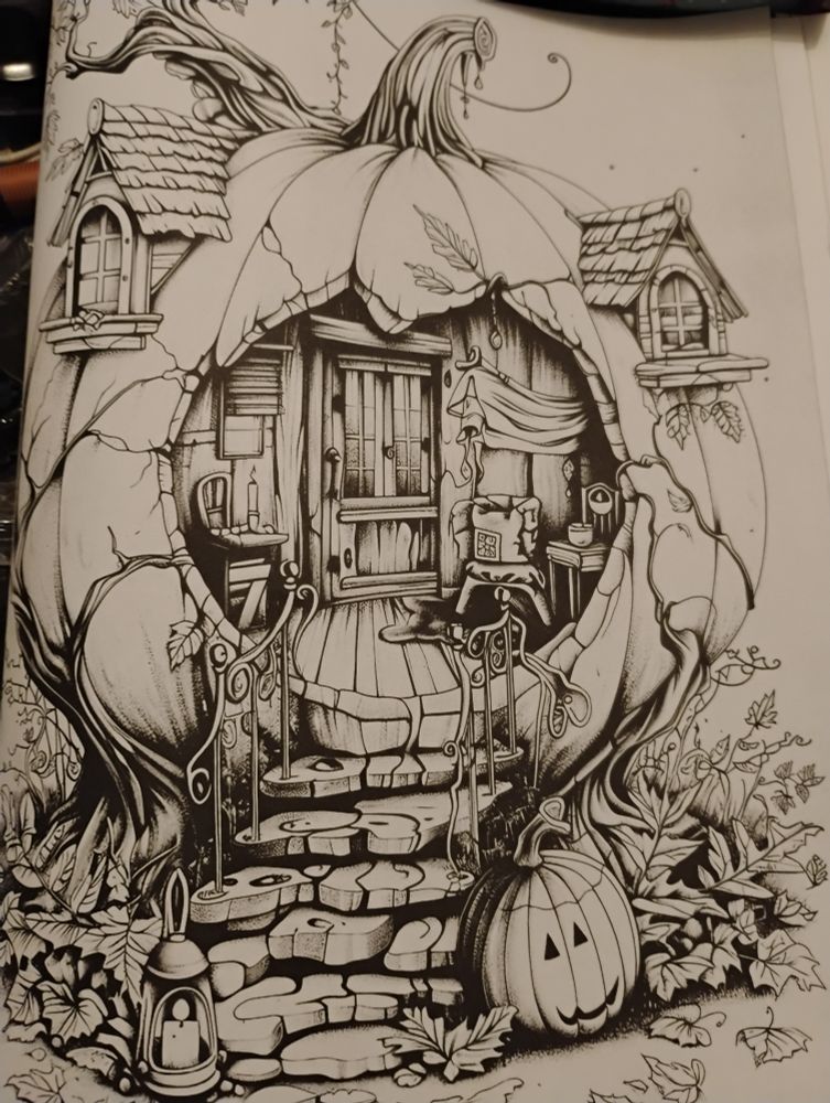 A blank, black and white coloring book page of a fairy house inside a hollowed-out pumpkin. A set of stone steps leads into the yard, where the leaves have fallen. An orange jack-o'-lantern sits by the steps. Leafy vines grow around the fairy house, which has two windows carved into the top. 