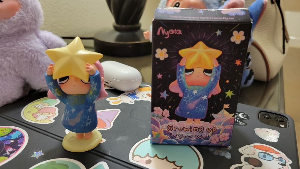 Nyota Growing Up by Your Way blind box figurine. Girl with shooting star nightgown holding a big star up in the air.