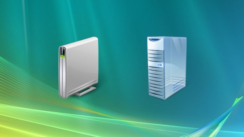 The “PC” and “server” icons used by Windows Vista through 8.1. The PC is a sleek tall silver rectangle with a stand, and a green LED on the front. The “server” is a glassy blue tower box with horizontal vent lines, a power button, and an opening for front I/O.