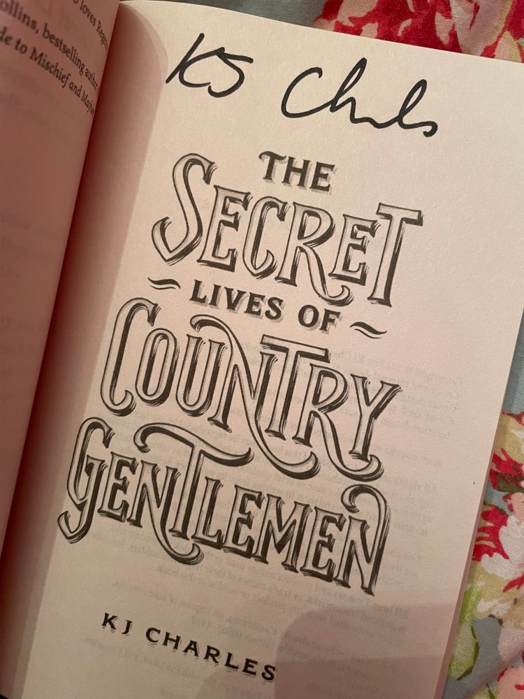The title page of "The Secret Lives of Country Gentlemen" by KJ Charles with a signature at the top.