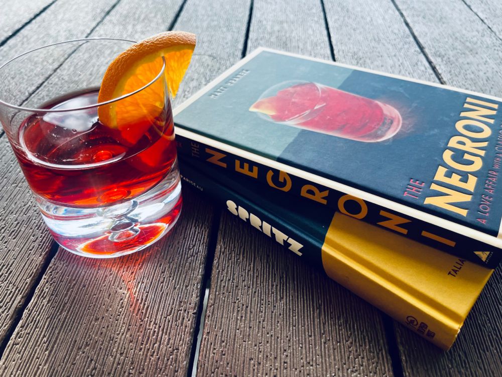 A Negroni and two small books.

- Spritz by Talia Baiocchi & Leslie Pariseau
- Negroni by Matt Hranek
