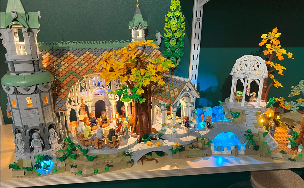 A LEGO Lord of the Rings, Rivendell set, lit with LED lights.  In the center there are minifigs of the fellowship and Elrond, seated around a LEGO One Ring, which is always comically huge, like, how did Gollum not know it was in Bilbo's pocket? It's bigger than his head!