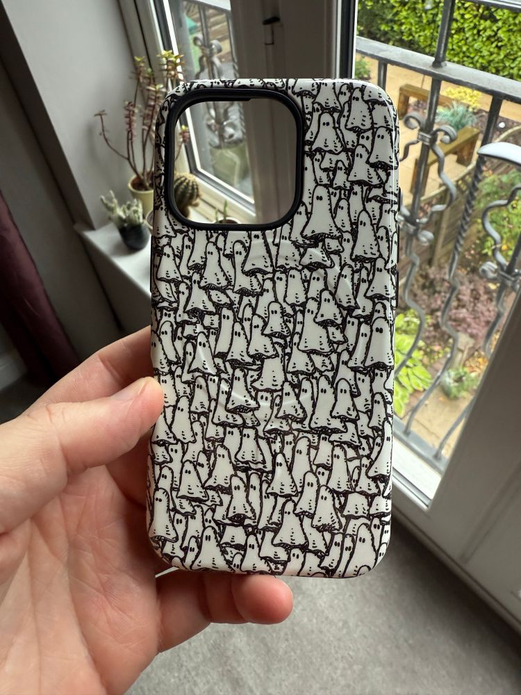 A picture of my new phone cover that is covered in tiny ghosts, like a swarm of them. All drawn by me.