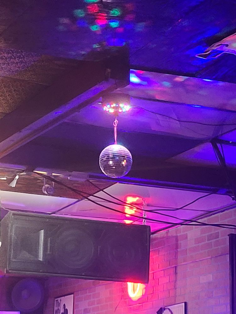 Photo of the smallest disco ball glistening in rainbow light 