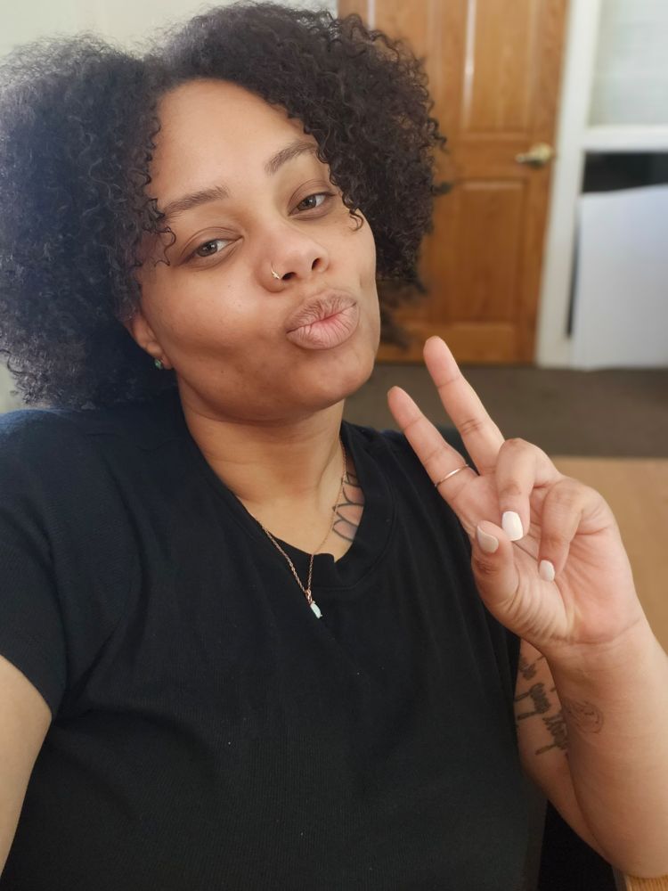 A woman doing the peace sign 