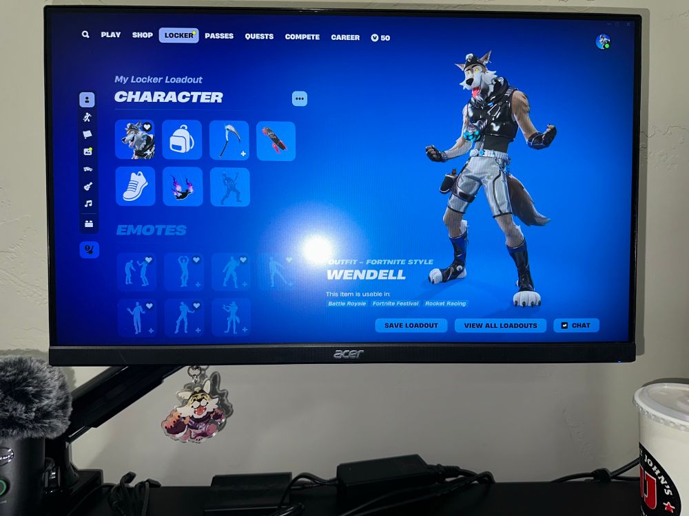 A photo of a monitor with Fortnite on it showing Wendell and bellow the monitor is an acrylic charm of Wendell made by Burntt 