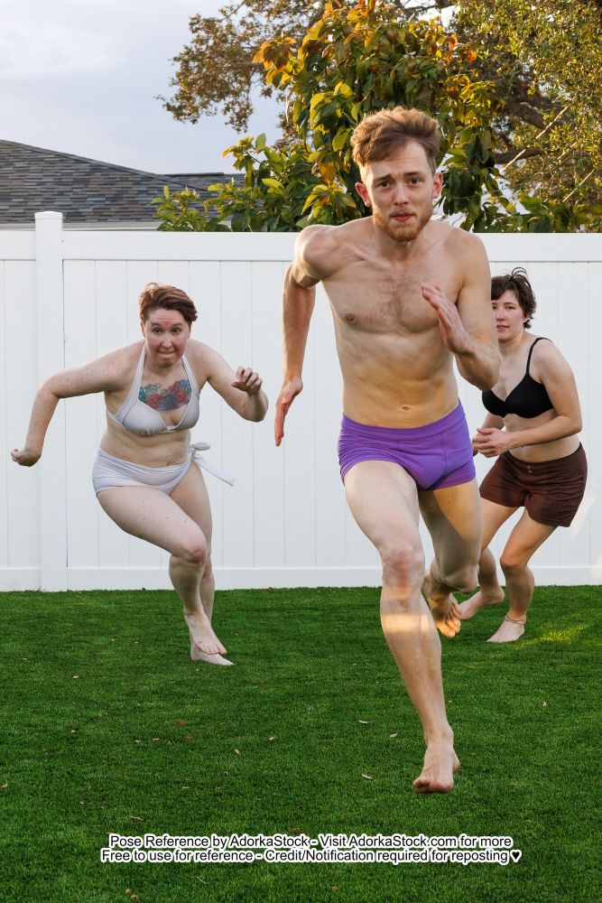 Three people in various stages of running toward the camera 