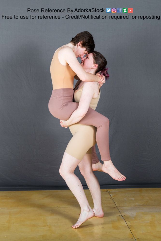 two models, one carrying the other in front of her and they are forehead to forehead smiling