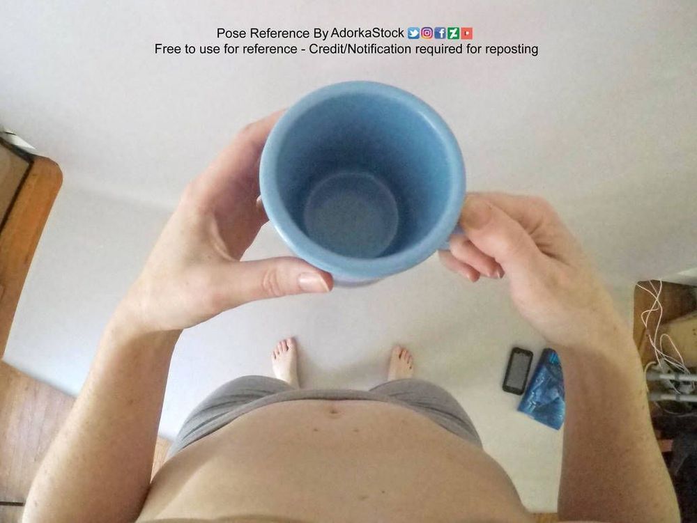 A point-of-view photograph looking down at an empty blue mug in hand.