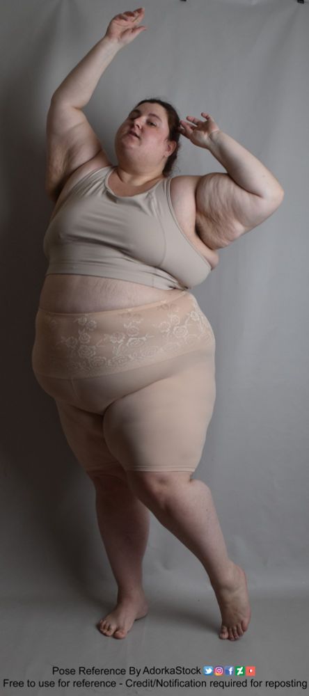 Pose reference of a fat, white, female model in a standing, front facing pose, weight shifted onto her right foot, with both arms raised, one near her face the other over her head. Her chin is raised.