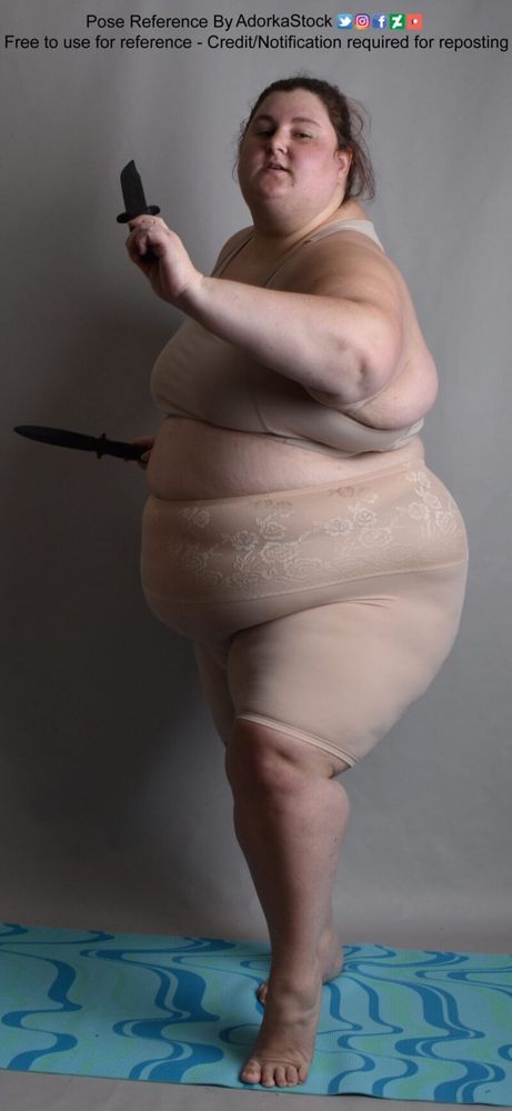 fat white female model holding two knives moving as it attacking towards the camera