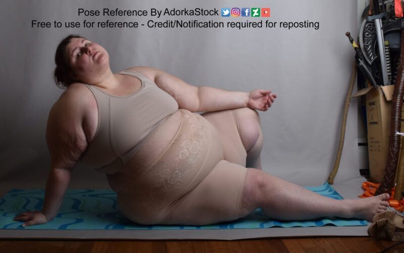 fat white model reclined on the floor head tipped back one arm resting on a raised knee