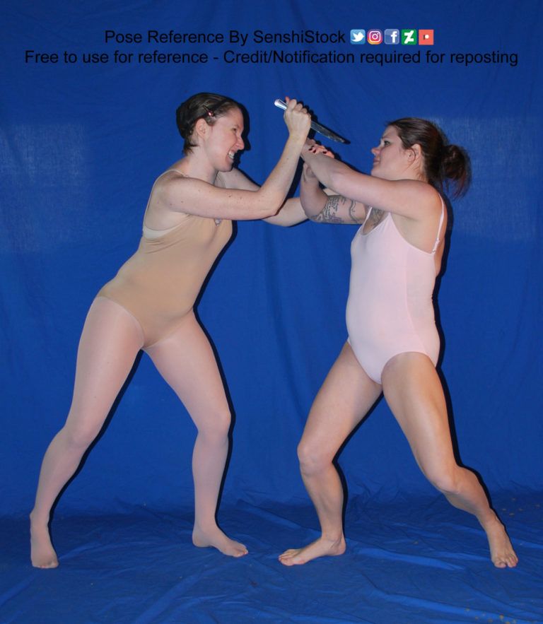 pose reference of two models in a physical fight one holding a knife the other trying to block the attack 