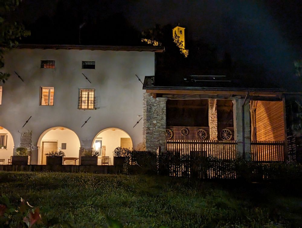 Ca' Panisacco at night with the sanctuary of Santa Maria di Panisacco lit up in the background