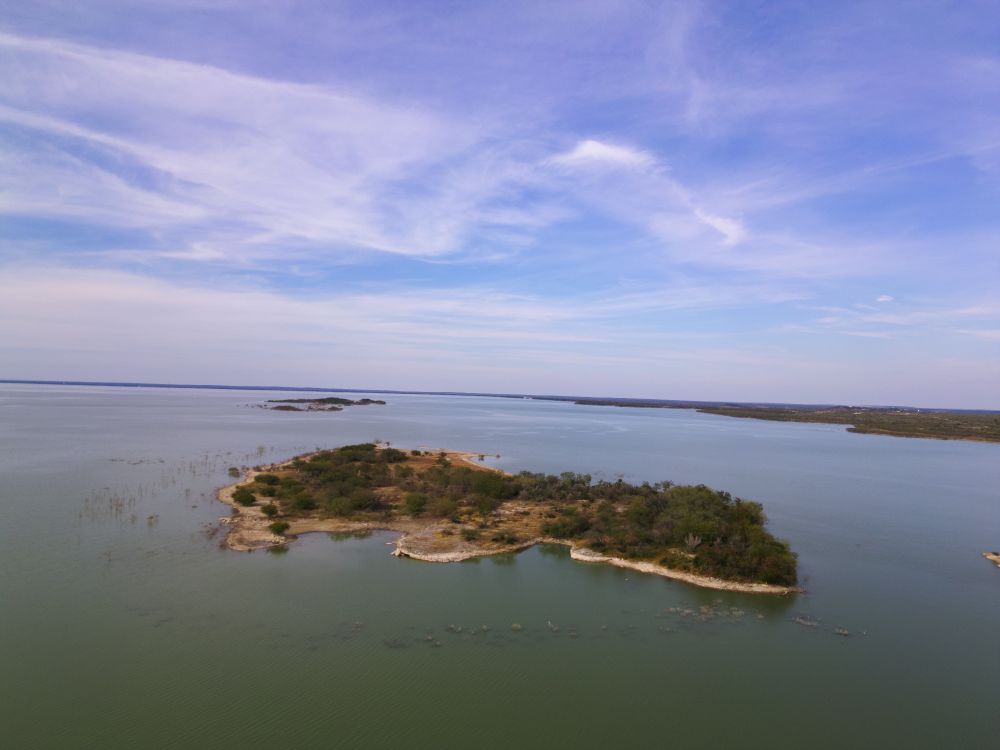 A tiny island on the side of a lake