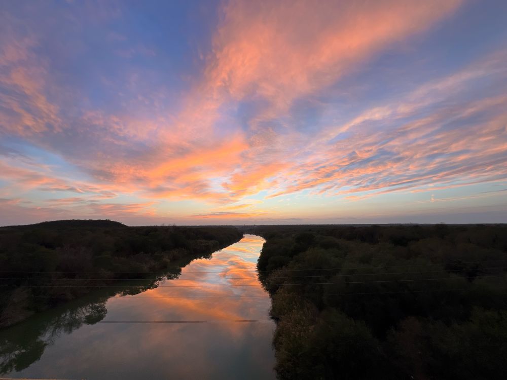 A picture of a sunset over a river 