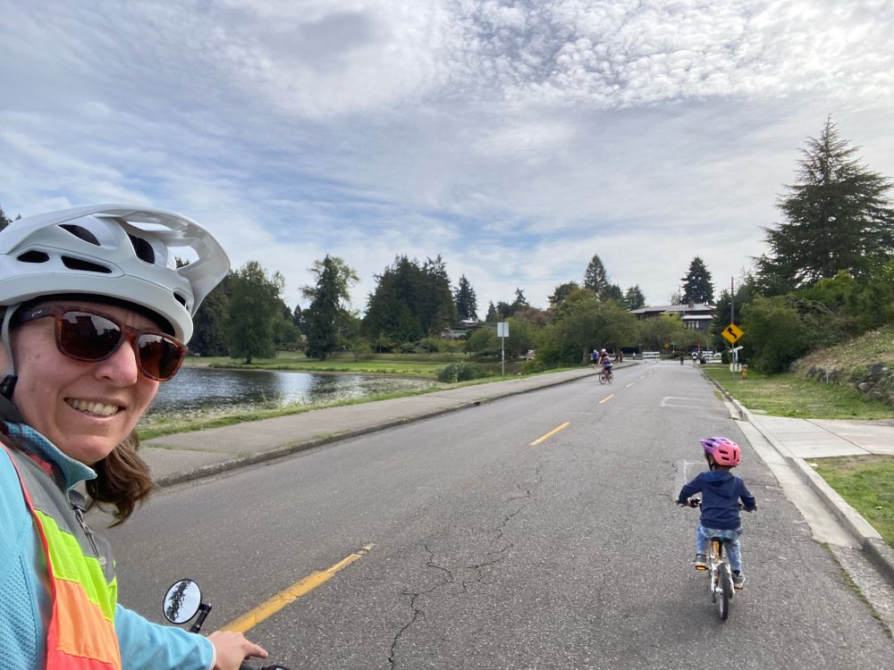 A child riding a bike down a street closed to cars.