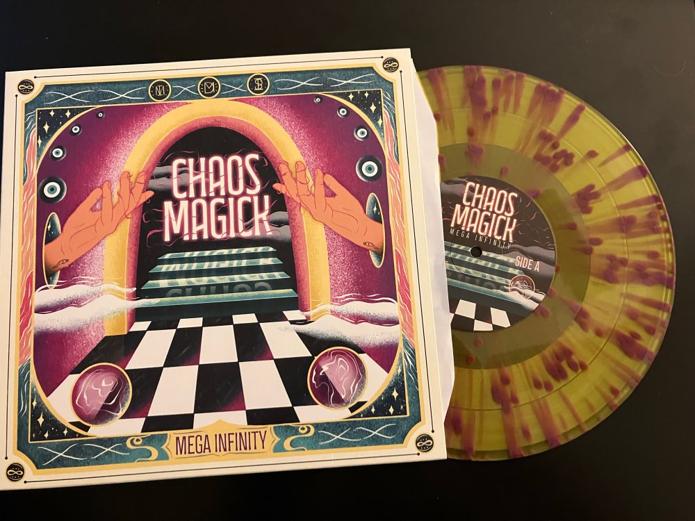 Mega Infinity’s Chaos Magick album, showing the bright colored cover and the yellow purple tie dyed looking record itself. The songs are amazing too! :)