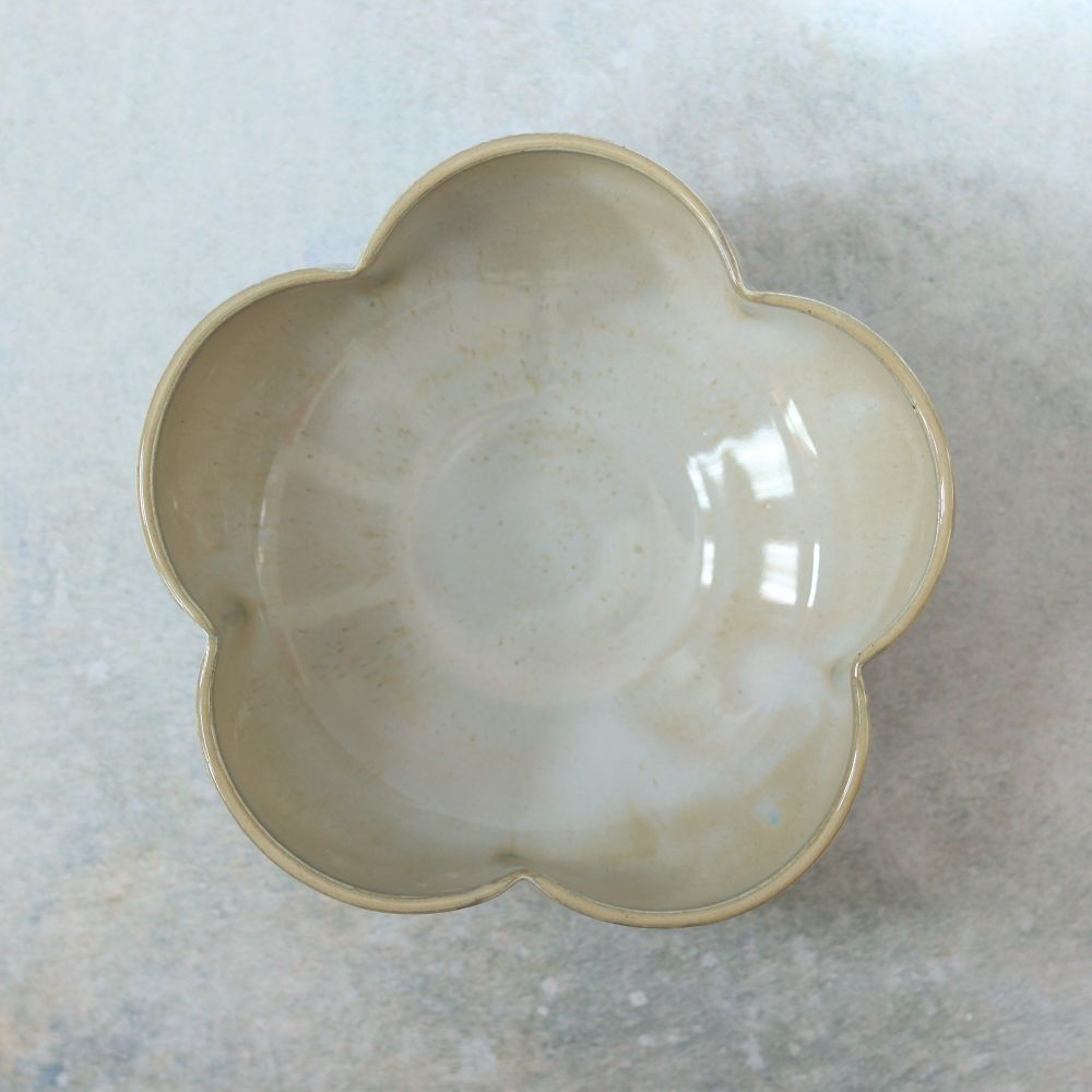 Top down view of a grey flower-shaped bowl with five petals 