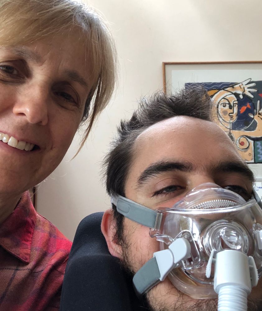 Alex wearing breathing apparatus in his last months of life, with his mother Emma