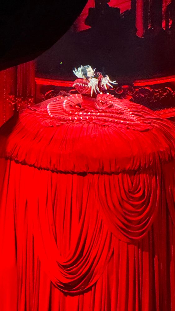 Lady Gaga in a multiple story red dress at The Mayhem Ball
