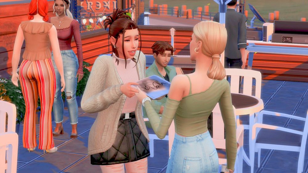 Macie is handing over her autograph to Courtney who is absolutely ecstatic. In the background the other band members are chatting. 