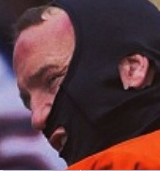 Peyton Manning wearing a black face mask with his forehead sticking out 
