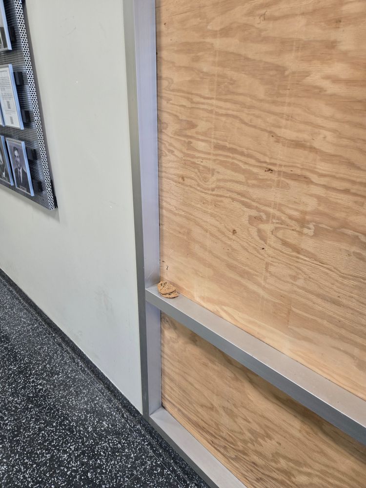 Hallway with a ledge with two cookies stacked on a railing. 