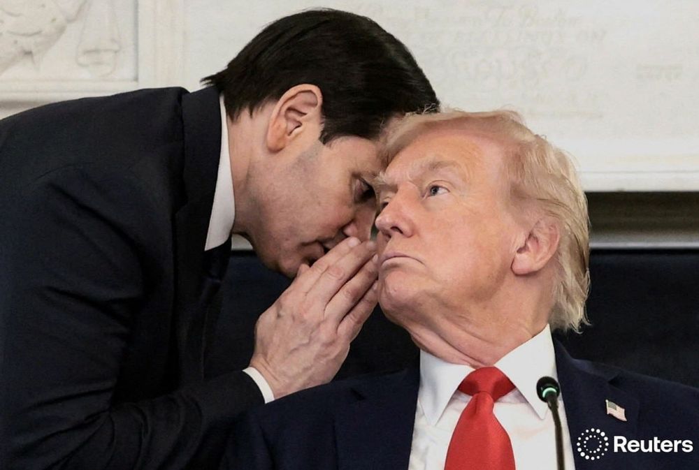 Marco Rubio whispering to Donald Trump. 