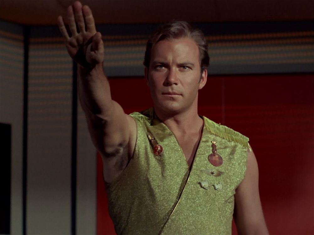 Captain Kirk in the Mirror universe, doing a fascist salute, ignoring the other image. 